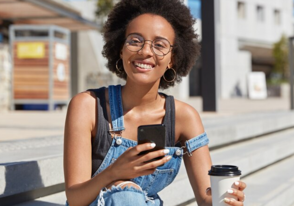 Happy person holding cell phone